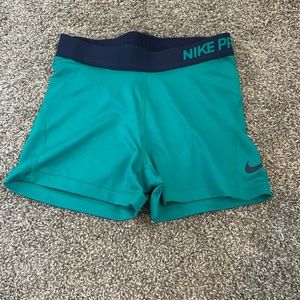 Teal Nike pros with navy blue letters